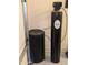 Water softener system next to a metal garage door track is essential for maintaining clean water in the home at 3212 E Constance Way, Phoenix, AZ 85042