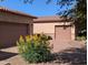 Double garages offer plenty of parking with yellow flowers near a brick driveway at 3212 E Constance Way, Phoenix, AZ 85042