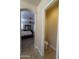 View from hallway towards bedroom featuring a bed, ceiling fan, blinds, and a separate toilet room on right at 3212 E Constance Way, Phoenix, AZ 85042