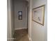 Hallway features tile flooring, neutral walls and framed artwork at 3212 E Constance Way, Phoenix, AZ 85042