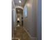 Hallway featuring an arched entryway, travertine floors, natural light, and access to various rooms in the home at 3212 E Constance Way, Phoenix, AZ 85042