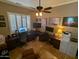 Functional home office setup with built-in desk, tiled floors, shuttered window, and ceiling fan at 3212 E Constance Way, Phoenix, AZ 85042