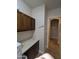 View of laundry room area with wood cabinets and a granite countertop for folding at 3212 E Constance Way, Phoenix, AZ 85042