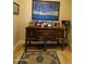 Staged living area featuring blue decorative painting, wood buffet, and area rug at 3212 E Constance Way, Phoenix, AZ 85042