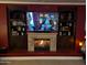 Cozy living room with a fireplace and custom built-in shelving at 3212 E Constance Way, Phoenix, AZ 85042