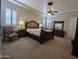 Expansive primary bedroom featuring large windows with shutters, a ceiling fan, and soft carpet at 3212 E Constance Way, Phoenix, AZ 85042