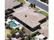 Stunning aerial view of a backyard oasis with a pool, spa, covered patio, and lush landscaping at 3464 E Dartmouth St, Mesa, AZ 85213