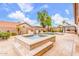 A relaxing backyard offers a pool and hot tub, adorned with stone accents and lush greenery for a serene outdoor living at 3464 E Dartmouth St, Mesa, AZ 85213