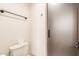 Bathroom featuring a toilet, towel rack, and frosted glass shower door at 3464 E Dartmouth St, Mesa, AZ 85213
