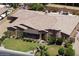 Beautiful custom home with a circular tower, stone accents, and a well-manicured lawn at 3464 E Dartmouth St, Mesa, AZ 85213