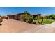 Exterior view of the home with a paver driveway, stone accents, and mature landscaping at 3464 E Dartmouth St, Mesa, AZ 85213