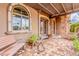Inviting front porch with brick flooring, arched windows, and a decorative wood pergola at 3464 E Dartmouth St, Mesa, AZ 85213