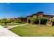 Expansive front yard with desert landscaping and green lawn enhances the curb appeal of this home at 3464 E Dartmouth St, Mesa, AZ 85213