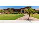 Beautiful desert landscaping graces the front yard with lush green lawn providing curb appeal at 3464 E Dartmouth St, Mesa, AZ 85213