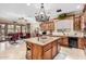 Spacious kitchen features custom wood cabinets, granite countertops, and a large central island at 3464 E Dartmouth St, Mesa, AZ 85213