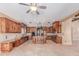 Expansive kitchen boasts custom wood cabinetry, a central island, and tiled floors at 3464 E Dartmouth St, Mesa, AZ 85213