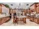 Spacious kitchen features custom wood cabinets, granite countertops, and a large central island at 3464 E Dartmouth St, Mesa, AZ 85213