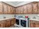 Laundry room with ample wooden cabinets, counter space, and a washer and dryer at 3464 E Dartmouth St, Mesa, AZ 85213