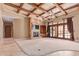 Beautiful living room featuring a beamed ceiling, fireplace, and access to the outdoors at 3464 E Dartmouth St, Mesa, AZ 85213
