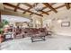 Open living room with coffered ceilings, a large sofa, and views to the kitchen at 3464 E Dartmouth St, Mesa, AZ 85213