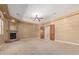 Spacious living room with fireplace and wood doors leading to other rooms at 3464 E Dartmouth St, Mesa, AZ 85213