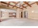 Open-concept living room flowing into the kitchen with coffered ceiling and natural light at 3464 E Dartmouth St, Mesa, AZ 85213