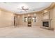 Cozy living room featuring a fireplace, neutral color palette, and access to the patio at 3464 E Dartmouth St, Mesa, AZ 85213