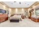 Comfortable main bedroom with cozy carpet, warm beige walls, recessed lighting, and a wooden dresser at 3464 E Dartmouth St, Mesa, AZ 85213