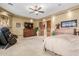Relax in this spacious main bedroom featuring a ceiling fan, recessed lights, and wood-look doors at 3464 E Dartmouth St, Mesa, AZ 85213