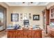 Home office with custom wood desk, display cabinet, and well-lit workspace at 3464 E Dartmouth St, Mesa, AZ 85213