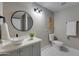 Modern bathroom featuring a stylish round mirror and vessel sink, complemented by neutral tones at 350 N 9Th St, Coolidge, AZ 85128