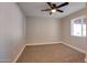 Cozy bedroom with neutral carpeting, a ceiling fan and a window allowing natural light at 350 N 9Th St, Coolidge, AZ 85128