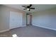 Bedroom with large closet, neutral walls, ceiling fan, and carpet at 350 N 9Th St, Coolidge, AZ 85128