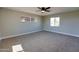 Spacious carpeted bedroom with natural lighting from two large windows and ceiling fan at 350 N 9Th St, Coolidge, AZ 85128