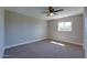 Bedroom with neutral walls, ceiling fan, carpet, and window at 350 N 9Th St, Coolidge, AZ 85128