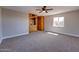 Bedroom featuring carpet, ceiling fan, and a closet with wooden doors for ample storage at 350 N 9Th St, Coolidge, AZ 85128