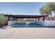 Spacious covered carport with concrete floor and a white privacy wall at 350 N 9Th St, Coolidge, AZ 85128