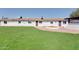 Exterior shot of a home with manicured lawn and a backyard patio area at 350 N 9Th St, Coolidge, AZ 85128