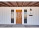 Detailed view of the ornate wood front door with sidelights and house numbers at 350 N 9Th St, Coolidge, AZ 85128