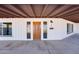 Covered front entrance with an ornate wood door and modern exterior lighting at 350 N 9Th St, Coolidge, AZ 85128