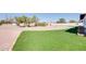 Expansive front yard with lush grass, mature trees, and circular driveway at 350 N 9Th St, Coolidge, AZ 85128