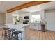 Modern kitchen with white cabinets, stainless steel appliances, a wooden beam, and a center island at 350 N 9Th St, Coolidge, AZ 85128