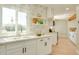 Modern kitchen with white cabinetry, stainless steel appliances, a big window and a tiled backsplash at 350 N 9Th St, Coolidge, AZ 85128