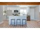 Well-lit kitchen featuring a center island, white cabinets, stainless appliances, and hardwood floors at 350 N 9Th St, Coolidge, AZ 85128