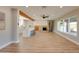 Bright, open-concept living room featuring hardwood floors, stone fireplace and modern ceiling fan at 350 N 9Th St, Coolidge, AZ 85128