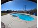 Inviting backyard pool with a concrete patio and a shed, perfect for outdoor relaxation and entertaining at 350 N 9Th St, Coolidge, AZ 85128