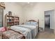 Cozy bedroom with a comfortable bed, bookshelf, and a doorway that leads to an attached bathroom at 3602 W Barcelona Dr, Chandler, AZ 85226