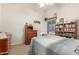 Comfortable bedroom featuring a cozy bed, dresser, bookshelf, and a window with natural light at 3602 W Barcelona Dr, Chandler, AZ 85226