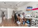 Brightly lit craft room with sewing machines, storage, wood floors, and a view into the kitchen at 3602 W Barcelona Dr, Chandler, AZ 85226