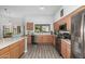 Bright kitchen featuring stainless appliances, plenty of wooden cabinets, and a window overlooking the backyard at 3602 W Barcelona Dr, Chandler, AZ 85226